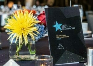Image of a flower and a program from Avivo Night of Champions