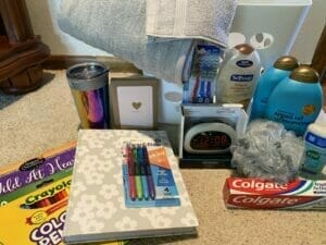 Adult welcome basket with basic living supplies.