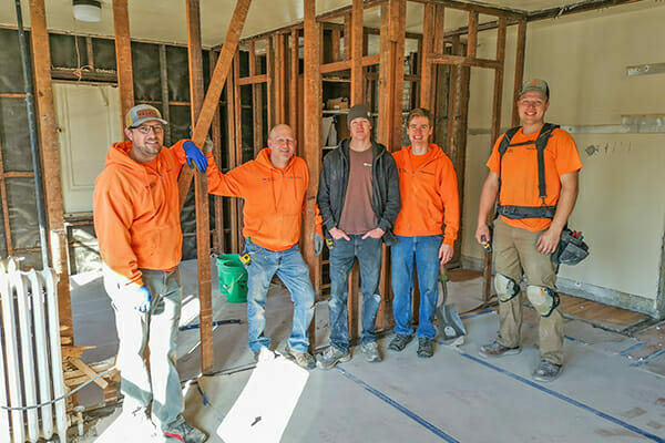 The team from build partner The Kingdom Builders, in the early stages of remodeling one of Avivo's family recovery housing units.