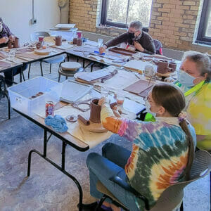 Avivo staff and program participants in Avivo's Community Support Program create ceramics as party of a weekly ceramics activity.
