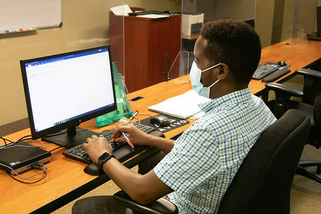 A student learns Microsoft Office basics as part of a prerequisite to Avivo's Office Support Specialist career training program
