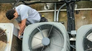 HVAC technician works on an air conditioner.