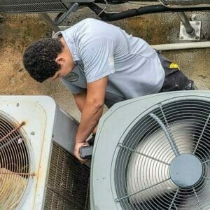 HVAC technician works on an air conditioner.