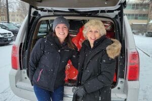 Two volunteers drop off a donation at Avivo.