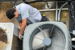 HVAC technician works on air conditioning
