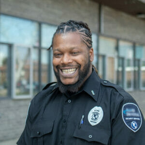 Portrait of smiling Avivo male adult participant wearing security uniform