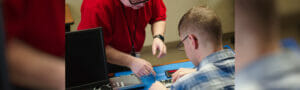 Image showing a person showing another person how to install technology as part of Avivo's IT Support career education program.