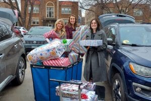 A group of staff from Northwestern Mutual Edina drop off holiday gifts for Avivo's Adopt-A-Family program in 2023.