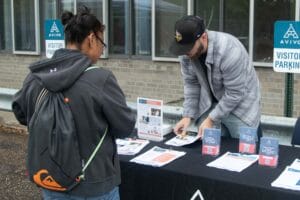 An Avivo employee hands out flyers at an Avivo event.