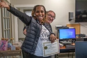 A graduate from Avivo's Career Education programs poses for a photo.